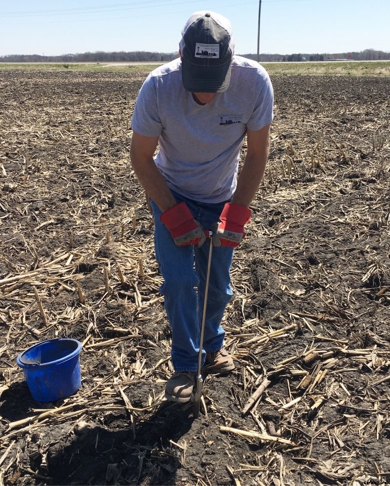 Del Johnston uses a soil probe to take a soil sample